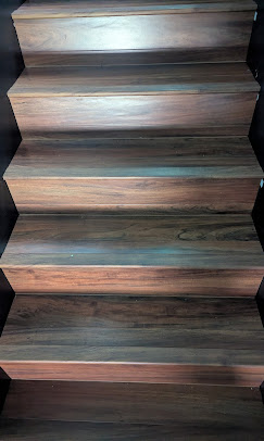 A finished staircase with wood treads